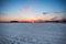 Crimson Sunset over Snowy American Corn Fields in Winter with Bl