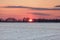 Crimson Sunset over Snowy American Corn Fields in Winter with Bl