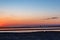 Crimson sunset on the sea at low tide