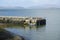 Crinan harbour basin wall and inflatable boat clear sea in Argyll and Bute Scotland