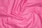 Crinkled pink material texture or background
