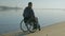 Cripple in wheelchair near river, disabled faith in future, man with