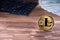 Criptocurrency concept golden litecoin coin on wooden background next to keyboard and dollars