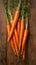 Crisp carrots arranged on a wooden table, farm fresh goodness