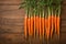 Crisp carrots arranged on a wooden table, farm fresh goodness