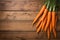 Crisp carrots arranged on a wooden table, farm fresh goodness