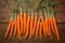 Crisp carrots arranged on a wooden table, farm fresh goodness