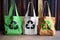 crisp recycle symbols painted on eco-friendly canvas bags
