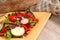 Crisp salad on a yellow plate with rustic bread