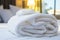 Crisp white towel, thoughtfully placed on a plush resort bed