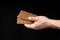 Crisp whole grain breads in the male hand on black background