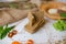 Crispbread tightened by a rope. Healthy food on a white background besid the ingredients in a wooden plate. .Lettuce with carrot