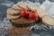 Crispbread, tomatoes and raw buckwheat on wooden piece