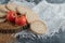 Crispbread, tomatoes and raw buckwheat on wooden piece