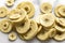 The crispness and lightness of banana chips by placing them on a clean, white marble background.