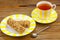 Crispy appetizing bread with strawberries on a plate on  wooden background