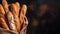 Crispy baguettes in packaging on a dark background, top view