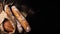 Crispy baguettes in packaging on a dark background, top view