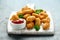 Crispy Battered scampi nuggets with ketchup on white wooden board