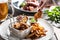 Crispy breaded chicken nuggets with french fries served on a plate with a dip and a salad