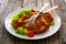 Crispy breaded fried pork chop and fresh vegetables on wooden table