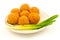 Crispy cheese balls with green onion on the plate