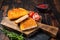 Crispy Cordon Blue Chicken fillet roll with ham and cheese served on a wooden board. Wooden background. Top view