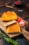 Crispy Cordon Blue Chicken fillet roll with ham and cheese served on a wooden board. Wooden background. Top view