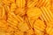 Crispy corrugated potato chips background. Junk food