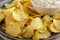Crispy Crinkle Potato Chips and French Onion Dip on a Plate, side view. Close-up