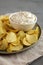 Crispy Crinkle Potato Chips and French Onion Dip on a Plate, side view. Close-up