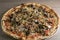 Crispy crusted pizza pie with sausage, onion, black olives, and Jalapenos.