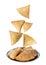 Crispy delicious samosas falling into plate on white background