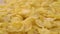 Crispy dry cornflakes fall in a heap in a slow motion. Macro.