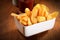 Crispy French Fries on Plate on Wooden Table