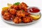 Crispy Fried Chicken Bites with Fresh Lemon Slices and Parsley Garnish Served with Tomato Ketchup on a White Plate Delicious