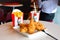 Crispy fried chicken & cup of drink served in retail background of KFC restaurant.