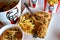 Crispy fried chicken & cup of drink served in retail background of KFC restaurant.