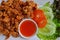 Crispy fried chicken tendon with chili sauce and vegetables