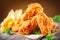 Crispy fried chicken wings on wooden table