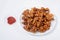 Crispy Fried Gobi Manchurian on white plate with ketchup on white background