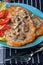 Crispy fried homemade potato pancakes with mushroom sauce