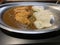 Crispy fried pork cutlet with curry and rice in stainless dish