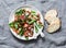 Crispy fried prosciutto, cherry tomatoes, spinach, parmesan salad on grey background