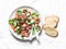 Crispy fried prosciutto, cherry tomatoes, spinach, parmesan salad on light background, top view