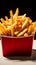 Crispy fries in a red fast food box, isolated