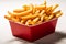 Crispy fries in a red fast food box, isolated