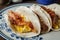 Crispy glazed bacon and fried eggs breakfast tacos