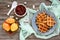 Crispy golden vanilla waffles with pear jam on a wooden background.