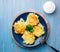 Crispy hashed browned potatoes on blue background, top view.